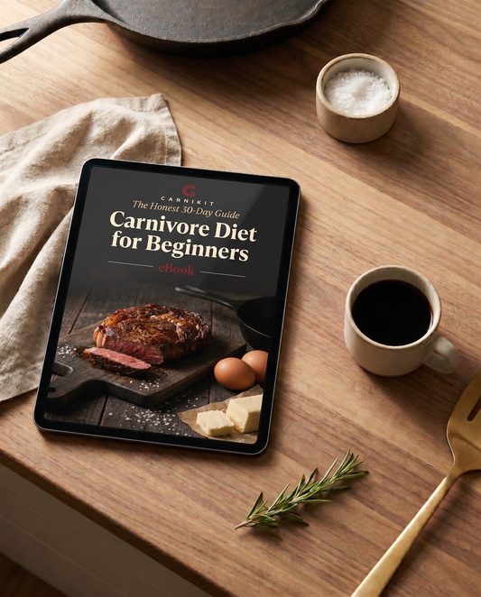 Tablet displaying 'Carnivore Diet for Beginners' on a wooden table with food items.