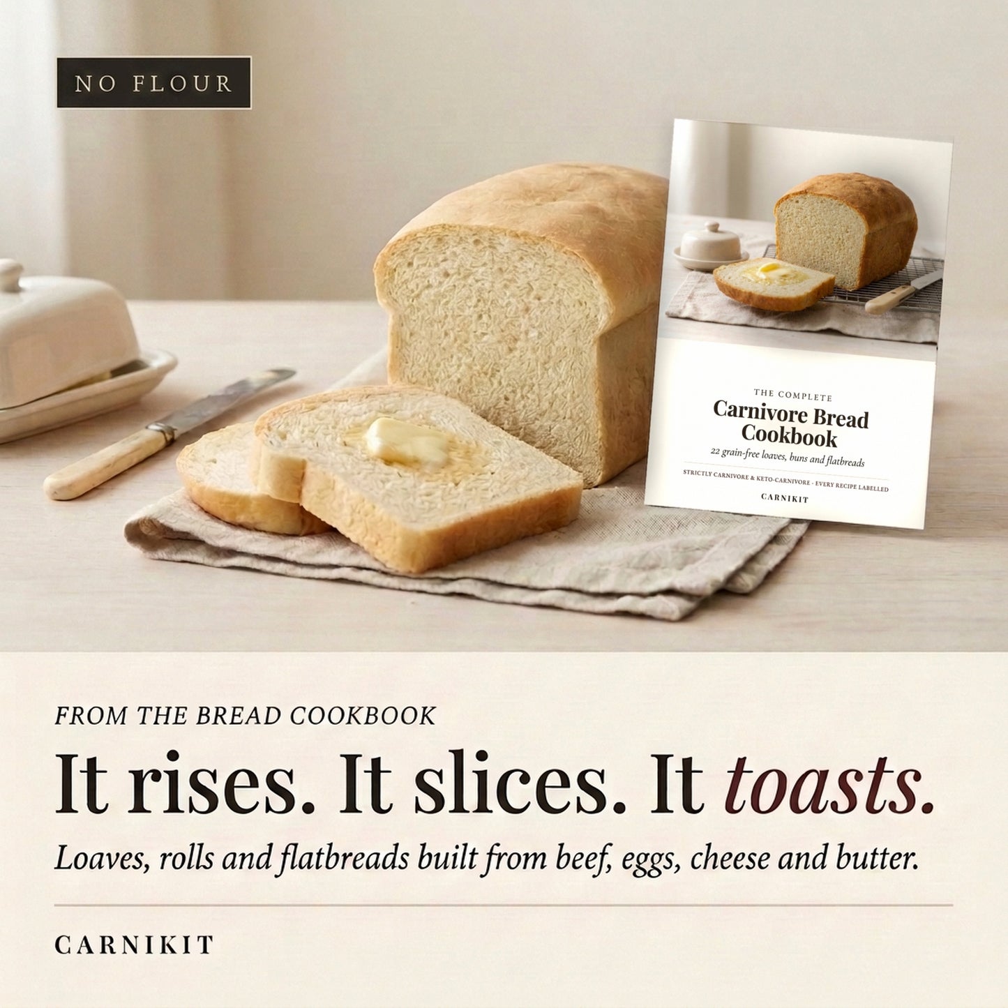 A loaf of bread and two slices with butter are arranged on a table beside a cookbook titled 'The Carnivore Bread Cookbook' by Carnikit. The scene is styled like a warm kitchen setting, with a butter dish and knife in the background.