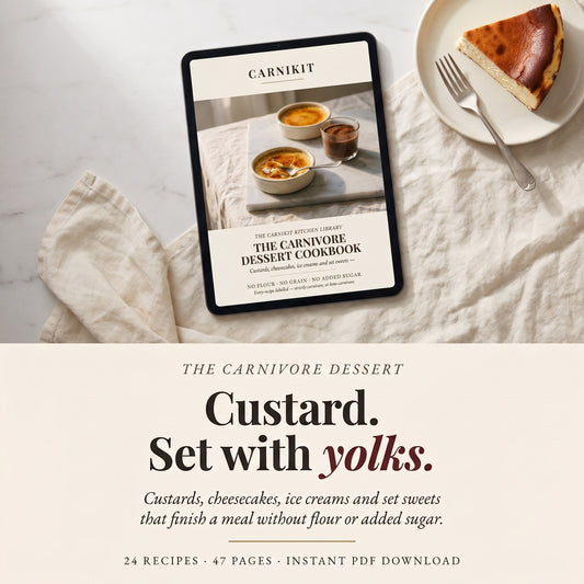 A tablet displaying the cover of 'The Carnivore Dessert Cookbook' by Carnikit, styled on a cream fabric surface next to a slice of cheesecake on a plate. Below, text reads 'The Carnivore Dessert Custard.